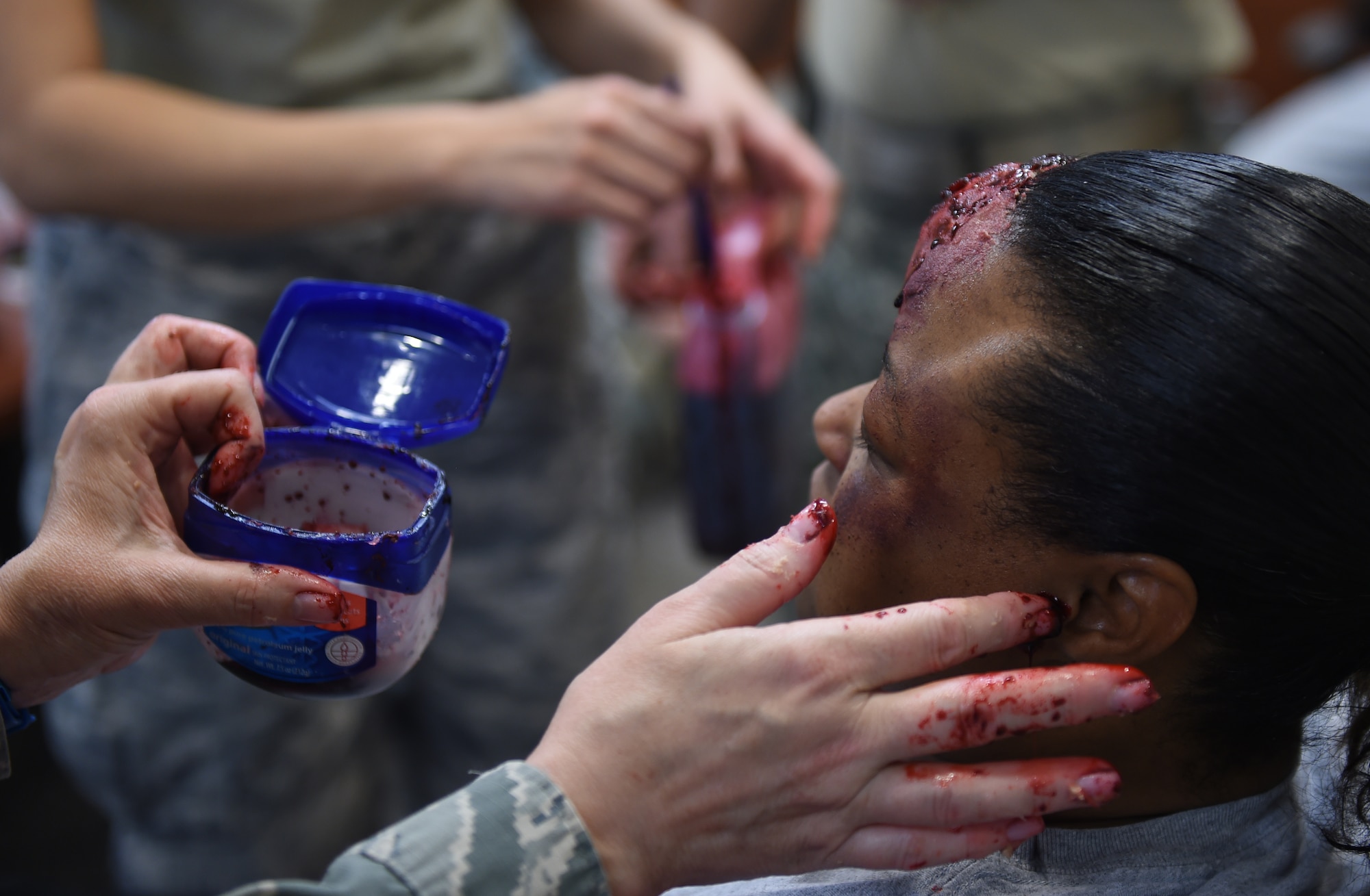 A Team Buckley member gets moulage applied during the Panther Lighting exercise March 25, 2015, on Buckley Air Force Base, Colo. Panther Lightning is Buckley AFB’s version of the Strategic Command exercise, Global Lightning, which is an Air Force-wide exercise that focuses on all combatant commands and their missions. (U.S. Air Force photo by Airman 1st Class Emily E. Amyotte/Released)