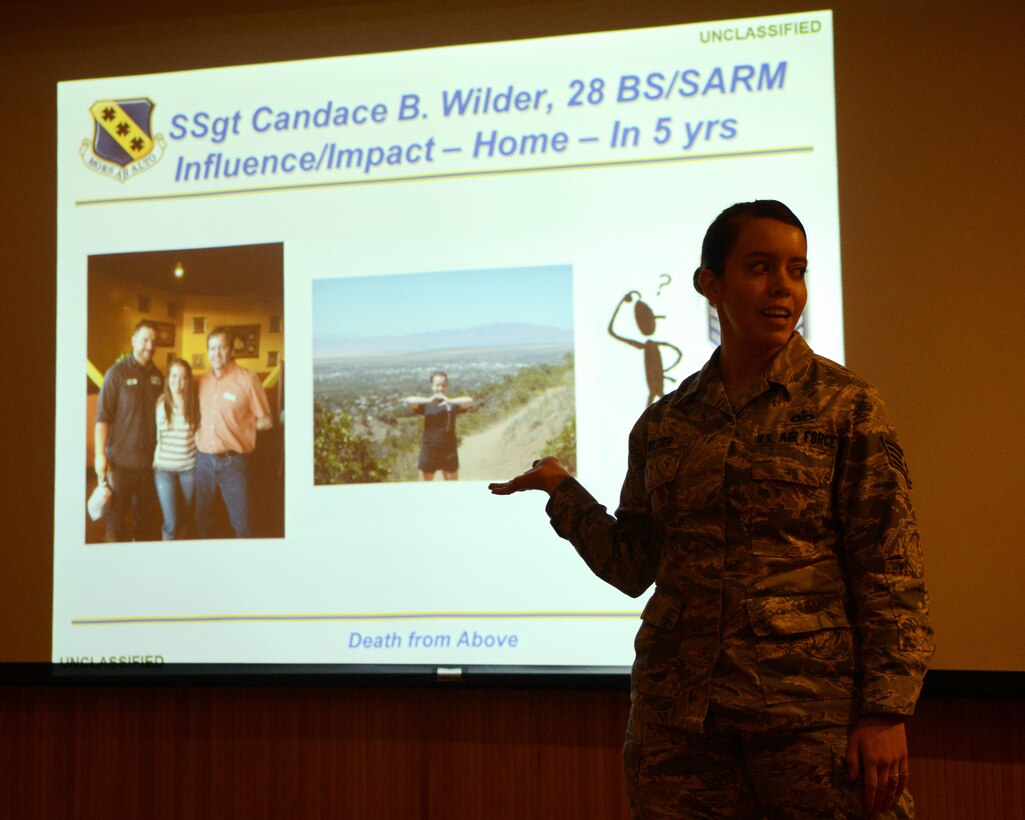 U.S. Air Force Staff Sgt. Candace Wilder, 28th Bomb Squadron aviation resource management assistant noncommissioned officer in charge, introduces herself during a weekly leadership meeting March 19, 2015, at Dyess Air Force Base, Texas. Wilder spent the day with Chief Master Sgt. Eddie Webb, 7th Bomb Wing command chief, as a part of his monthly “Shadow the Chief” program. She recently won the 2014 Air Force Aviation Resource Manager Award for Airman of the Year and the 2014 Team Dyess Annual Award for Airman of the Year. (U.S. Air Force photo by Airman 1st Class Kedesha Pennant/Released)