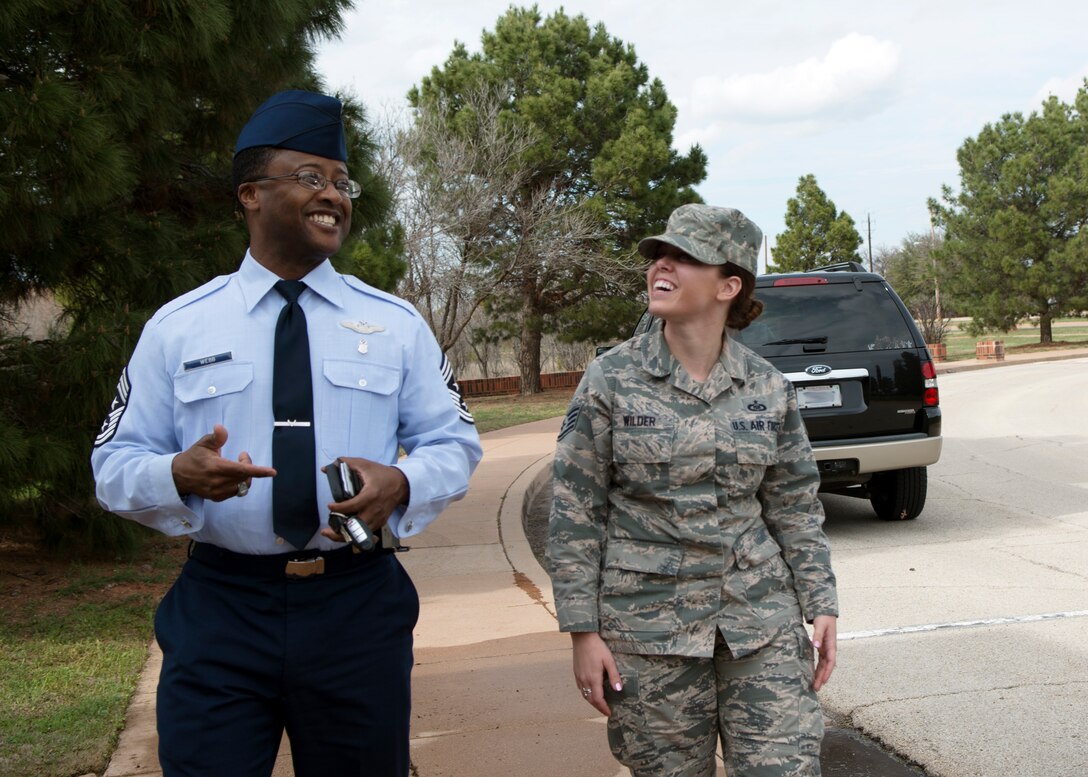 U.S. Air Force Chief Master Sgt. Eddie Webb, 7th Bomb Wing command chief, shares a laugh with Staff Sgt. Candace Wilder, 28th Bomb Squadron aviation resource management assistant noncommissioned officer in charge, March 19, 2015, at Dyess Air Force Base, Texas. Wilder spent the day with the command chief as a part of his monthly “Shadow the Chief” program. (U.S. Air Force photo by Airman 1st Class Kedesha Pennant/Released)