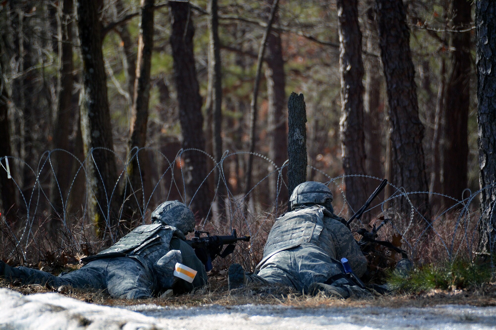 Airmen from the 570th Contingency Response Group, maintain a defensive fighting position during a mock attack from opposing forces, March 12, 2015, during Exercise EAGLE FLAG 15-2, at Joint Base McGuire-Dix-Lakehurst, New Jersey.  EF is designed for developing, testing and rehearsing the expeditionary combat support library of capabilities. (U.S. Air Force photo by Senior Airman Charles Rivezzo)