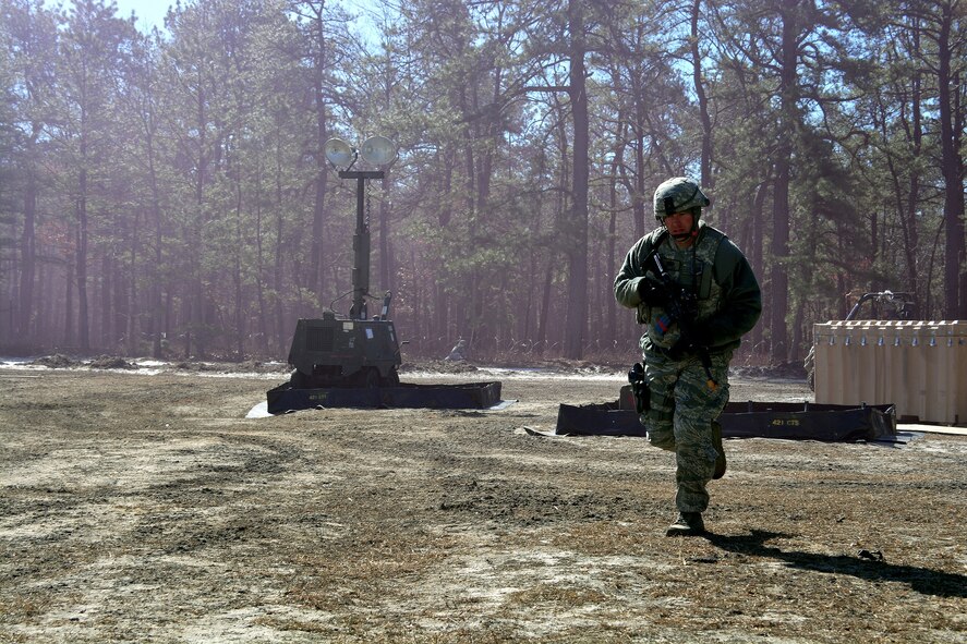 Tech. Sgt. Cory Little, 571st Global Mobility Readiness Squadron, runs for cover during a mock attack from opposing forces, March 12, 2015, during Exercise EAGLE FLAG 15-2, at Joint Base McGuire-Dix-Lakehurst, New Jersey. EF is designed for developing, testing and rehearsing the expeditionary combat support library of capabilities. (U.S. Air Force photo by Senior Airman Charles Rivezzo)