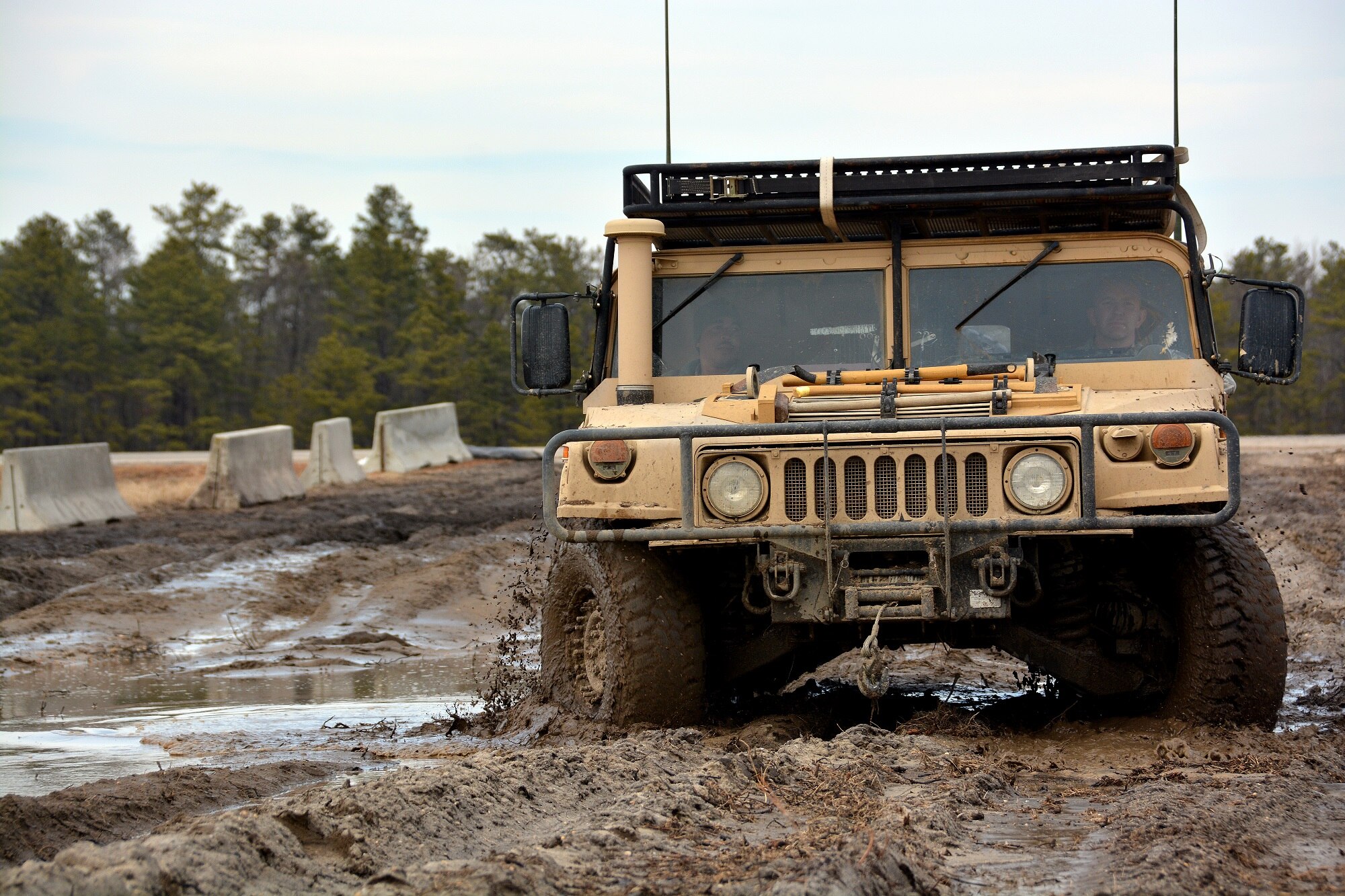 Tech. Sgt. Michael Ferris, 570th Global Mobility Readiness Squadron, drives a HUMVEE through the mud, March 11, 2015, during Exercise EAGLE FLAG 15-2, at Joint Base McGuire-Dix-Lakehurst, New Jersey. EF is a U.S. Air Force Expeditionary Center exercise used to execute and evaluate mobility operations and expeditionary combat support. (U.S. Air Force photo Senior Airman Charles Rivezzo)