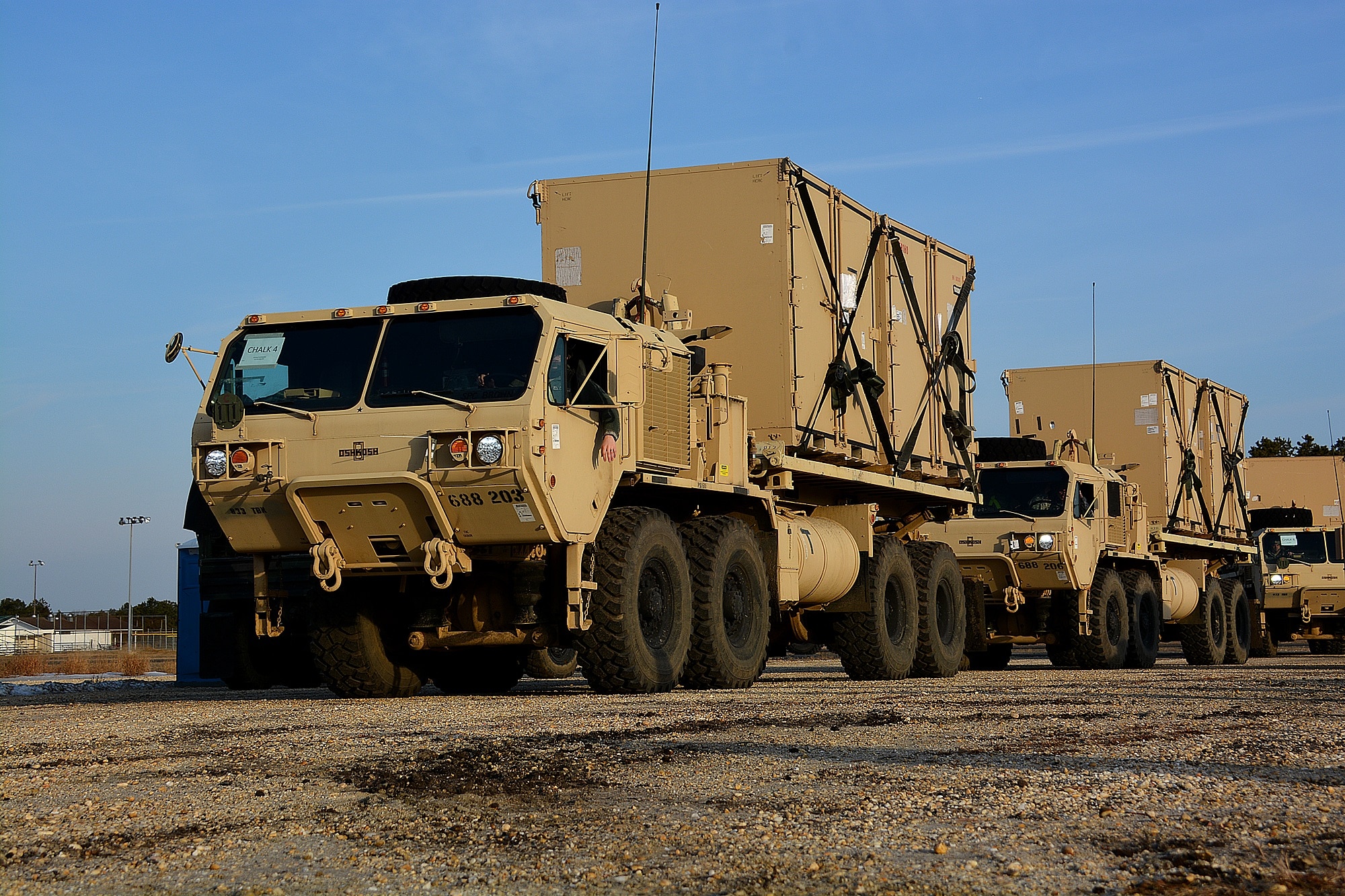 Heavy Expanded Mobility Tactical Trucks (HEMTTs) operated by U.S. Army Soldiers from the 688th Rapid Port Opening Element, based out of Fort Eustis, Virginia, transport humanitarian aid, March 10, 2015, during Exercise EAGLE FLAG 15-2, at Joint Base McGuire-Dix-Lakehurst, New Jersey. The weeklong, joint-service exercise focused on providing humanitarian aid and disaster relief to fictional refugee camps. (U.S. Air Force photo by Senior Airman Charles Rivezzo)
