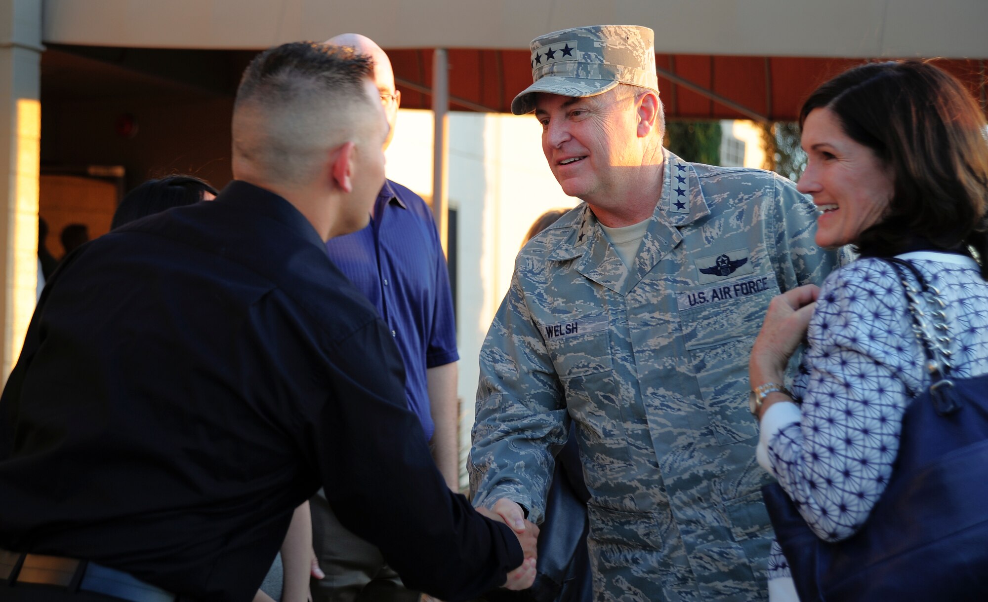 Air Force Chief of Staff Gen. Mark A. Welsh III shakes hands with Staff Sgt. Matthew Rompca, 355th Fighter Wing protocol as Betty Welsh looks on, upon arriving at Davis-Monthan Air Force Base, Ariz., March 25, 2015. During his visit to D-M, Welsh and his wife, Betty, met with Airmen from 12th Air Force (Air Forces Southern), 355th Fighter Wing, the 309th AMARG and additional tenet units. (U.S. Air Force photo by Staff Sgt. Angela Ruiz/released)