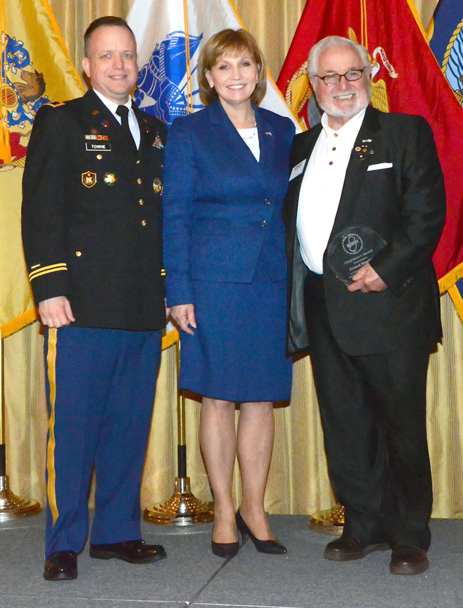 From left, Col. Mark Towne, Joint Base McGuire-Dix-Lakehurst deputy commander, New Jersey Lt. Gov. Kim Guadagno, and retired Sgt. Maj. Ernest J. Stoukas, pose for a photograph at the 2015 Employer Support of the Guard and Reserve Award Ceremony on Joint Base McGuire-Dix-Lakehurst, N.J., March 14, 2015. Stoukas was recognized by the lieutenant governor with both a New Jersey Chairman’s Award and a Presidential Service Award.  (Courtesy Photo)