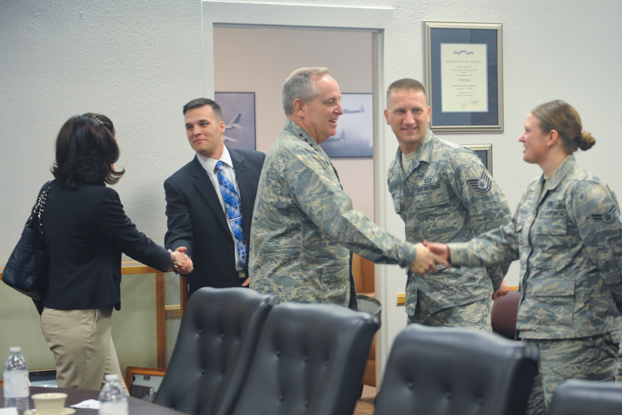 Air Force Chief of Staff Gen. Mark A. Welsh III is saluted by Senior Airman Erin Litchfield, 55th Electronic Combat Group acquisition operator, after presenting her with his coin at Davis-Monthan Air Force Base, Ariz., March 25, 2015. Welsh coined five superstars during a mission brief and thanked Airmen for their service. (U.S. Air Force photo by Cheyenne Morigeau/released)