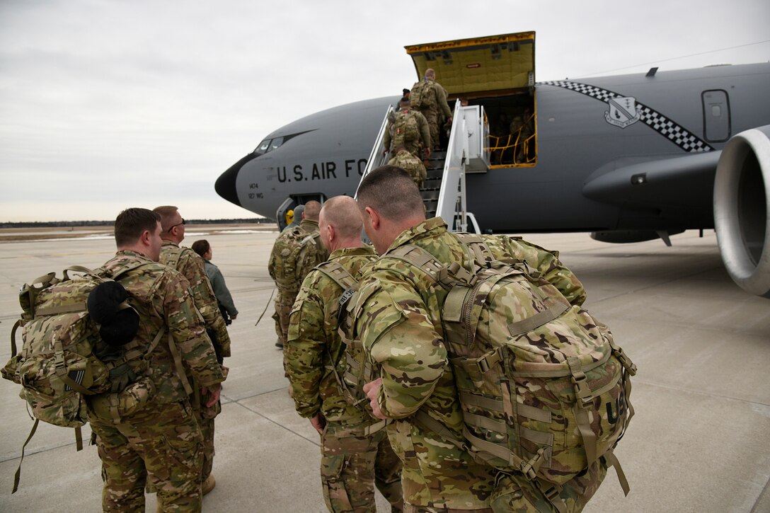 Members of the Michigan Army National Guard’s 119th Field Artillery board a Selfridge Air National Guard Base KC-135 Stratotanker at the Alpena Combat Readiness Training Center, Mich., March 20, 2015. 127th Logistics Readiness Squadron Airmen temporarily relocated to the Combat Readiness Center in Alpena, Mich., to support a mobilization exercise of the Michigan Army National Guard’s 119th Field Artillery. (U.S. Air National Guard photo by Senior Airman Ryan Zeski/Released)