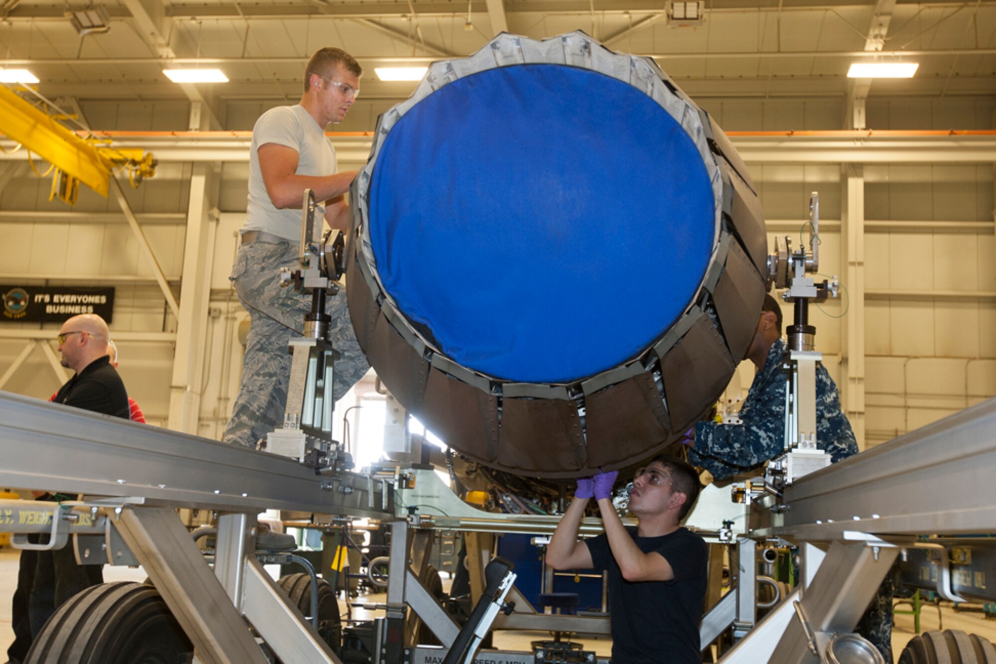A joint team of U.S. Air Force and U.S. Navy maintainers, DOD employees and Pratt and Whitney contractors work on an F135 engine March 17 as part of a week-long to provide verified technical procedures to be used by the entire JSF fleet, both nationally and internationally. (Photo by Tom Reynolds/Lockheed Martin)