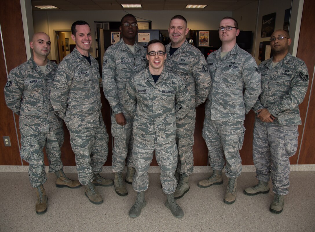 The 89th Operational Support Squadron/Operational Weather Squadron poses for a photo after being recognized and coined by the Col. Brad Hoagland, JBA/11th Wing commander, at the weather flight office on Joint Base Andrews, Md., March 13th, 2015. The 89 OSS/OSW is being recognized for correctly forecasted eight-out-of-eight winter weather system. (U.S. Air Force photo/Airman 1st Class Philip Bryant)