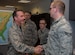 Senior Airman Kyle Alexander, 89th Operational Support Squadron/Operational Weather Squadron weather forecaster, is coined by Col. Brad Hoagland, JBA/11th Wing commander, at the weather flight office on Joint Base Andrews, Md., March 13th, 2015. The 89 OSS/OSW is being recognized for correctly forecasted eight-out-of-eight winter weather system. (U.S. Air Force photo/Airman 1st Class Philip Bryant)