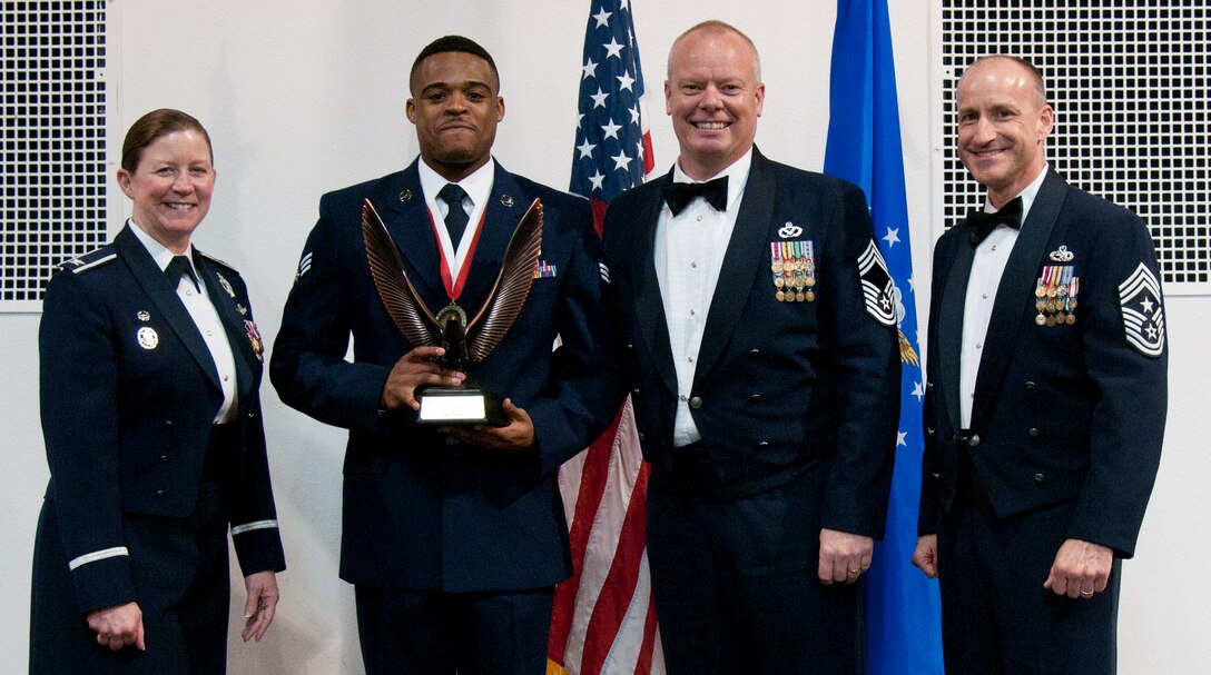 Senior Airman Clinton Robinson, 90th Logistics Readiness Squadron vehicle operator, receives the John L. Levitow Award from Col. Tracey Hayes, 90th Missile Wing commander, during the Airman Leadership School graduation March 25, 2015, at F.E. Warren Air Force Base, Wyo. The Levitow Award is the highest achievement for enlisted Airmen enrolled in U.S. Air Force professional military education. There are four levels of PME: ALS, Non-Commissioned Officer Academy, Air Force Senior NCO Academy and Chief Master Sergeant Leadership Course. (U.S. Air Force photo by Airman 1st Class Malcolm Mayfield)