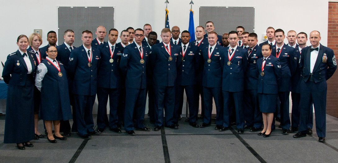 Col. Tracey Hayes, 90th Missile Wing commander, and Chief Master Sgt. Samuel Couch, 90th Missile Wing command chief, pose with Airman Leadership School Class 15-D March 25, 2015, on F.E. Warren Air Force Base, Wyo. ALS is a six-week course designed to prepare Airmen to assume supervisory duties as well as instruction in the practice of leadership and followership. Enlisted Airmen must graduate ALS before supervising other Airmen. (U.S. Air Force photo by Airman 1st Class Malcolm Mayfield)
