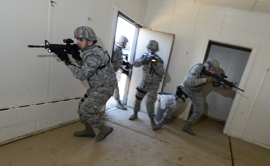 A 436th Security Forces Squadron breech team enters and quickly moves through a building during a Military Operations in Urban Terrain training scenario March 18, 2015, on Dover Air Force Base, Del. The airmen carry M-4 carbine rifles; a weapon tailored for use in close-quarters due to the collapsible stock and shortened barrel. The 2015 Dover Air Force Base Honorary Commanders took part in a tour of the 436th Mission Support Group to better understand the Group's mission and capabilities. (U.S. Air Force photo/Greg L. Davis)