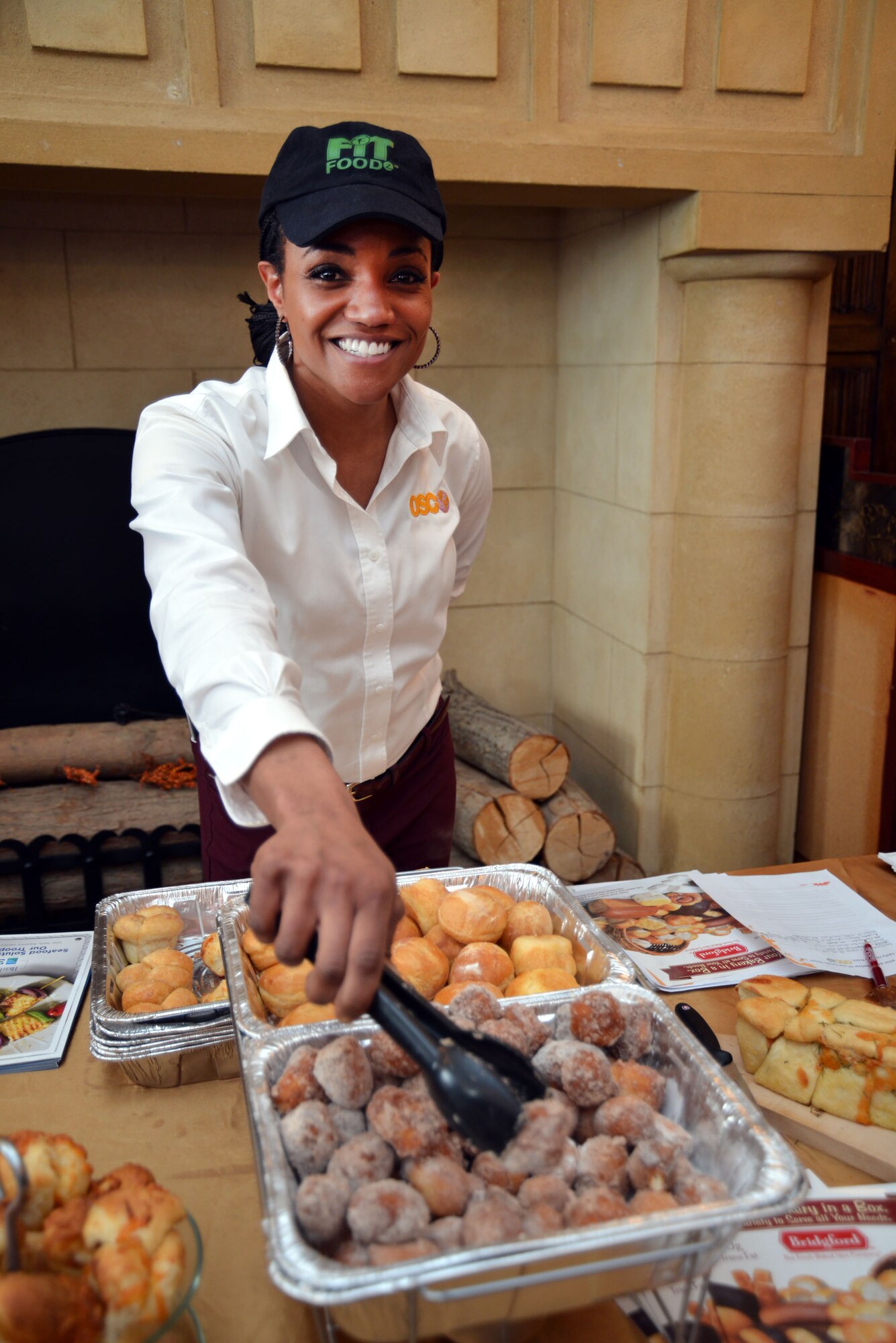 A vendor shows off cinnamon sopapillas and other dough products offered to customers at the 100th Force Support Squadron Gateway Dining Facility food show and customer appreciation event March 25, 2015, on RAF Mildenhall, England. Food company representatives from the United States, United Kingdom and Germany – many of whom were retired military – showcased new food items to customers by offering free samples, gifts and items of food to take home. Many of these items could potentially be added to the 100th Force Support Squadron Gateway Dining Facility menu based on feedback from customers. (U.S. Air Force photo by Karen Abeyasekere/Released)