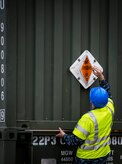 A Sailor with the Navy Munitions Command Unit Charleston adjusts an explosives warning sign March, 25, 2015, near the USNS Lewis and Clark (T-AKE-1) at Naval Weapons Station Wharf Alpha in Charleston, S.C. The Lewis and Clark is a replenishment naval vessel. In 2012, USNS Lewis and Clark became one of 12 ships that comprise the United States Marine Corps Maritime Prepositioning Program. Prepositioning ships provide quick and efficient movement of military equipment/supplies between operating areas without reliance on other nations' transportation networks. These ships give U.S. regional combatant commanders the assurance that they will have what they need to quickly respond in a crisis - anywhere, anytime. (U.S. Air Force photo/Airman 1st Class Clayton Cupit) 
