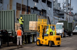 Sailors, Marines and civilians with the Navy Munitions Command Unit Charleston and Marine Corps Systems Command load cargo from the USNS Lewis and Clark (T-AKE-1) onto a transport vehicle March, 25, 2015, at Naval Weapons Station Wharf Alpha in Charleston, S.C. The Lewis and Clark is a replenishment naval vessel. In 2012, USNS Lewis and Clark became one of 12 ships that comprise the United States Marine Corps Maritime Prepositioning Program. Prepositioning ships provide quick and efficient movement of military equipment/supplies between operating areas without reliance on other nations' transportation networks. These ships give U.S. regional combatant commanders the assurance that they will have what they need to quickly respond in a crisis - anywhere, anytime. (U.S. Air Force photo/Airman 1st Class Clayton Cupit) 
