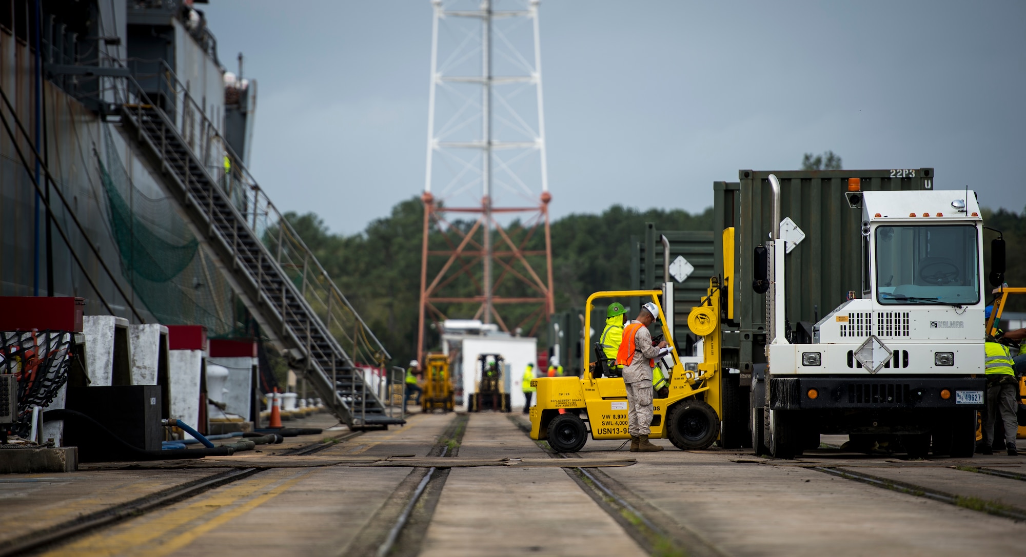 Sailors and Marines with the Navy Munitions Command Unit Charleston offload cargo from the USNS Lewis and Clark (T-AKE-1) March, 25, 2015, at Naval Weapons Station Wharf Alpha, Charleston, S.C. The Lewis and Clark is a replenishment naval vessel. In 2012, USNS Lewis and Clark became one of 14 ships that comprise the United States Marine Corps Maritime Prepositioning Program. Prepositioning ships provide quick and efficient movement of military equipment/supplies between operating areas without reliance on other nations' transportation networks. These ships give U.S. regional combatant commanders the assurance that they will have what they need to quickly respond in a crisis - anywhere, anytime. (U.S. Air Force photo/Airman 1st Class Clayton Cupit)