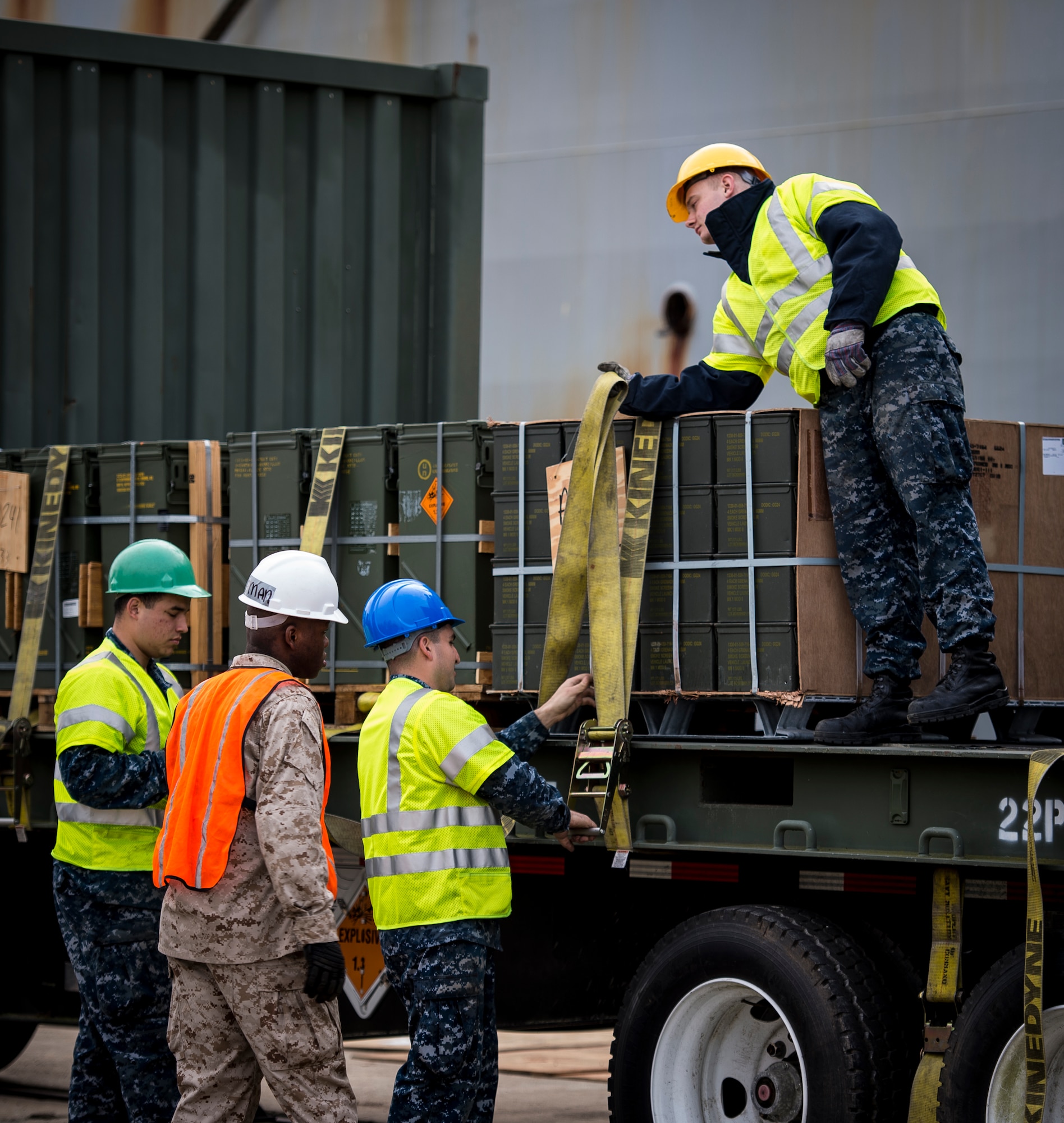 Sailors and Marines with the Navy Munitions Command Unit Charleston secure cargo from the USNS Lewis and Clark (T-AKE-1) on a transport vehicle March, 25, 2015, at Naval Weapons Station Wharf Alpha in Charleston, S.C. The Lewis and Clark is a replenishment naval vessel. In 2012, USNS Lewis and Clark became one of 14 ships that comprise the United States Marine Corps Maritime Prepositioning Program. Prepositioning ships provide quick and efficient movement of military equipment/supplies between operating areas without reliance on other nations' transportation networks. These ships give U.S. regional combatant commanders the assurance that they will have what they need to quickly respond in a crisis - anywhere, anytime. (U.S. Air Force photo/Airman 1st Class Clayton Cupit)