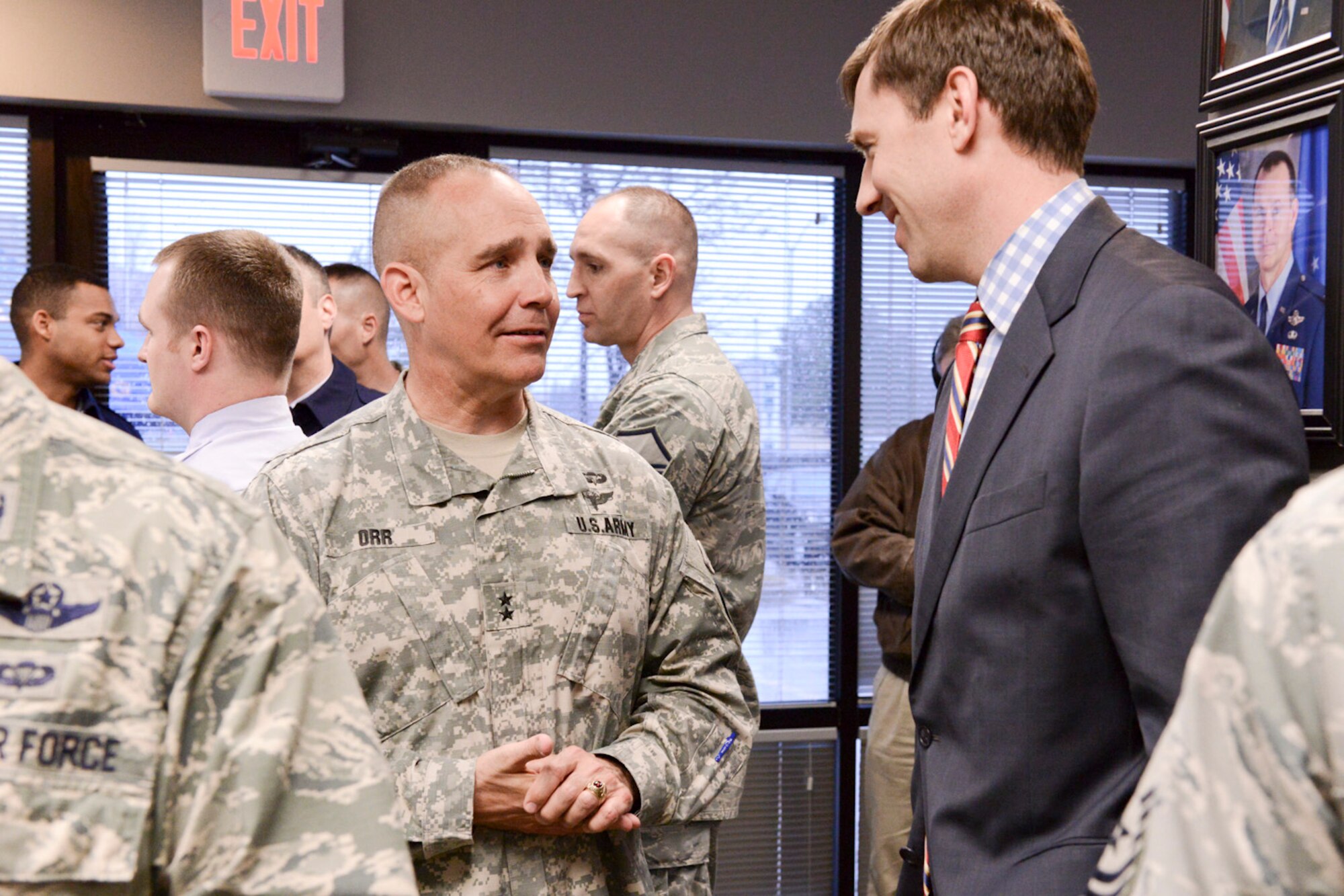 The Adjutant General of the Iowa National Guard, Maj. Gen. Timothy Orr (left), speaks to Council Person, Ward 2, West Des Moines, Iowa, John Mickelson (right), as members of the Iowa Air and Army National Guard celebrate the opening of the 132d Wing, Des Moines, Iowa off-site Recruiting Operation Center during a ribbon cutting ceremony held at the new Recruiting Operation Center in West Des Moines, Iowa on Tuesday, March 24, 2015.  (U.S. Air National Guard photo by Staff Sgt. Linda K. Burger/Released)