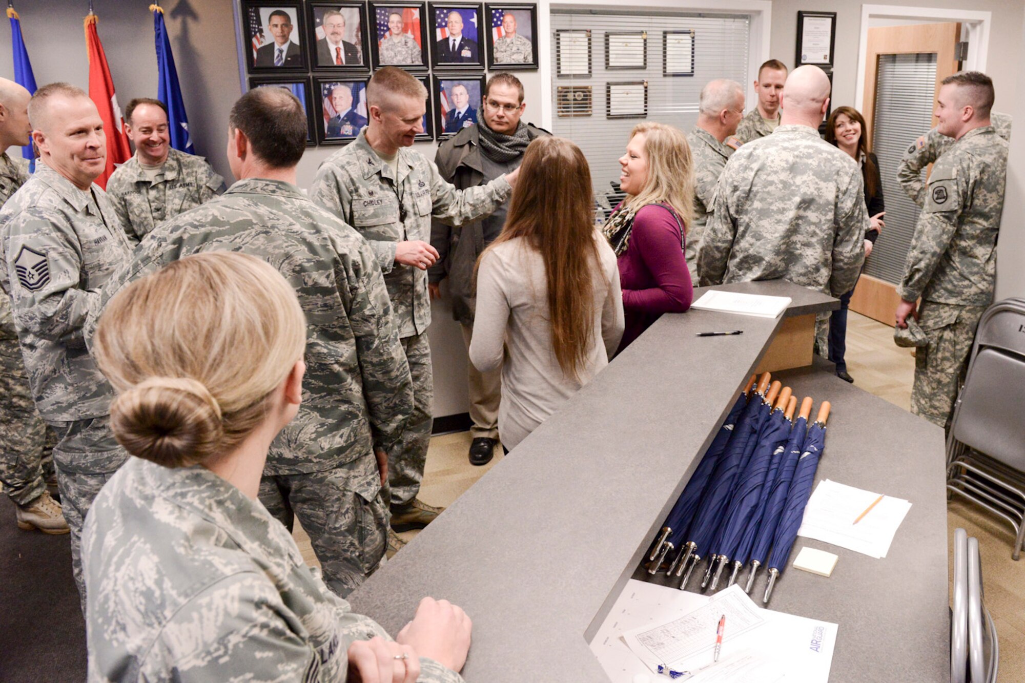Members of the Iowa Air and Army National Guard celebrate the opening of the 132d Wing, Des Moines, Iowa off-site Recruiting Operation Center during a ribbon cutting ceremony held at the new Recruiting Operation Center in West Des Moines, Iowa on Tuesday, March 24, 2015.  (U.S. Air National Guard photo by Staff Sgt. Linda K. Burger/Released)