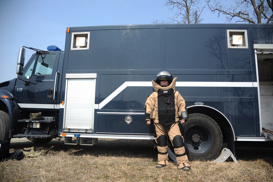 Tech. Sgt. Molly Callen, 8th Civil Engineer Squadron explosive ordnance disposal team lead, dons the Med-Eng EOD-9 bomb suit in front of the bomb squad emergency response vehicle March 20, 2015 at Kunsan Air Base, Republic of Korea. While the bomb suit provides protection from explosive hazards, the BSERV allows EOD personnel to rapidly respond to an emergency with all necessary equipment.