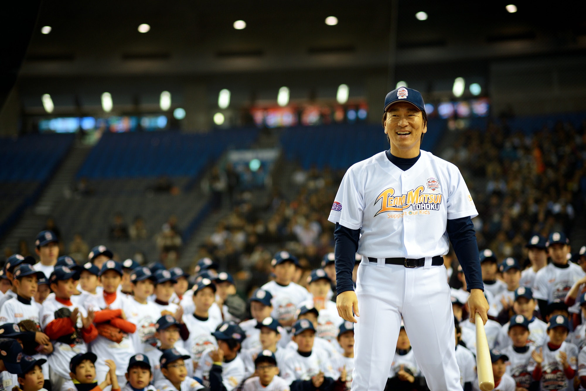 Hideki Matsui, retired New York Yankees baseball player, demonstrates how to hit a baseball for children during the Tomodachi Charity Baseball Game, March 21, 2015, at the Tokyo Dome, Japan. The game helped to raise awareness for children impacted by the Great East Japan Earthquake. (U.S. Air Force photo by Airman 1st Class Delano Scott/Released)