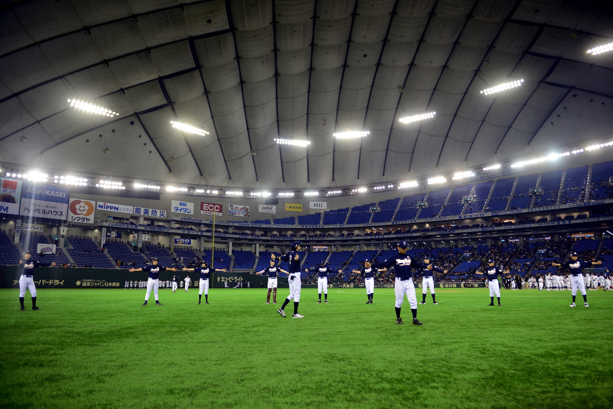 Players from Team Jeter warm up before the Tomodachi Charity Baseball Game, March 21, 2015 at the Tokyo Dome, Japan. Team Jeter played against Team Matsui in an effort to raise awareness about children affected by the Great East Japan Earthquake. (U.S. Air Force photo by Airman 1st Class Delano Scott/Released)