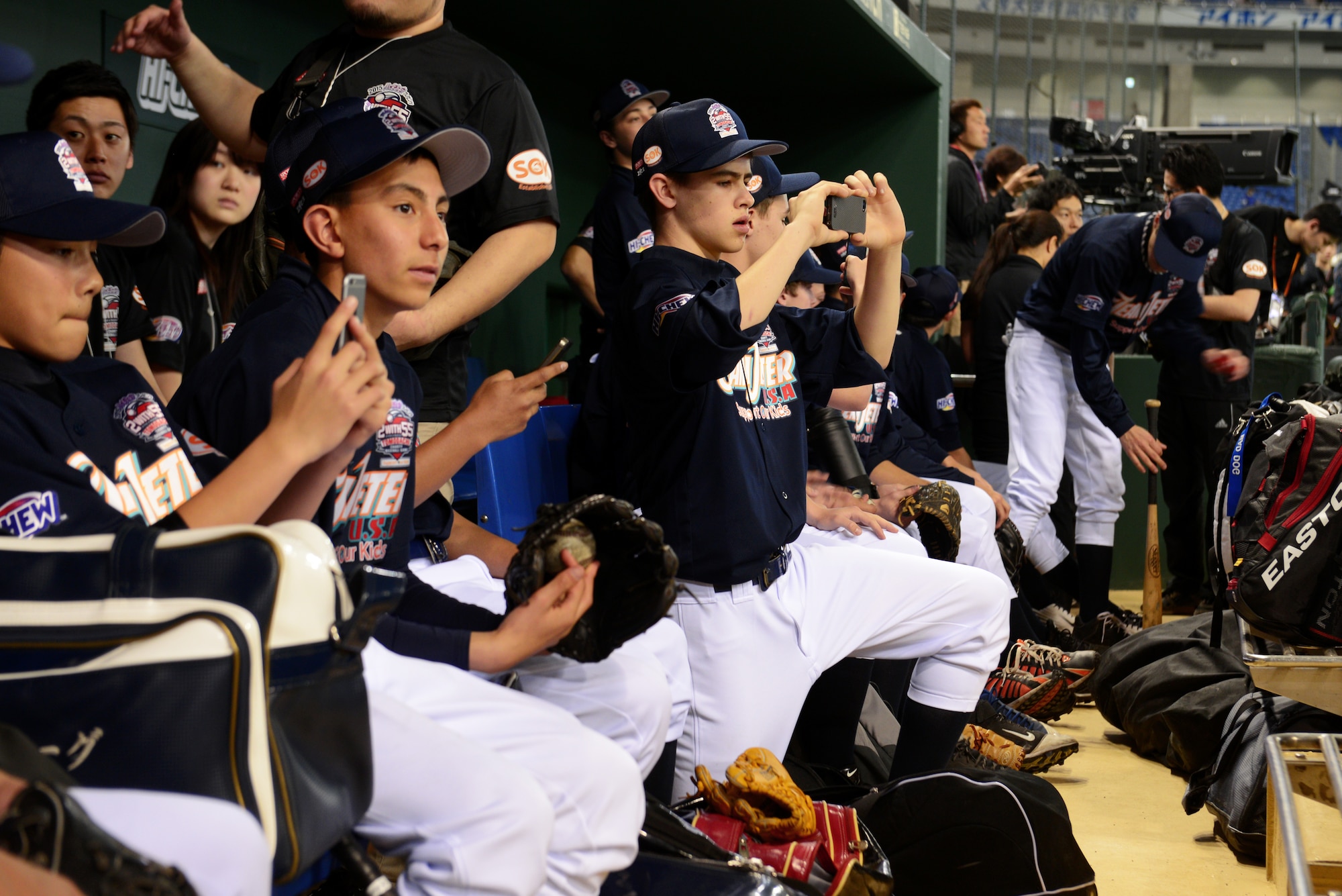 Players from Team Jeter take pictures inside the dugout of the Tokyo Dome, Japan, March 21, 2015. A member of Team Jeter said that he was thankful for this once-in-a-lifetime opportunity to not only meet baseball legends, but also to help raise awareness for children affected by the Great East Japan Earthquake. (U.S. Air Force photo by Airman 1st Class Delano Scott/Released)