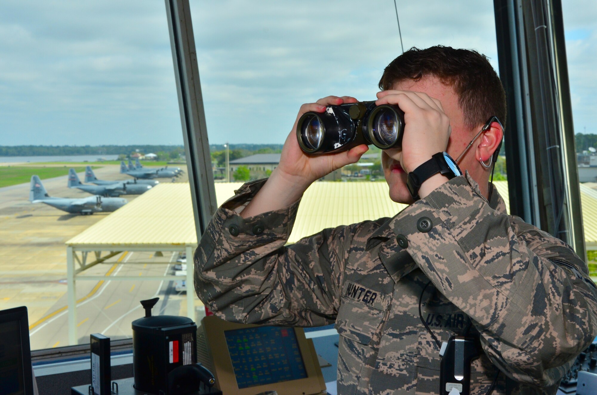 Senior Airman Hunter Gavin Hunter, 81st Operations Weather Flight air traffic control technician, monitors the exodus of 815th Airlift Squadron and 53rd Weather Reconnaissance Squadron aircraft during a hurricane evacuation exercise March 24, 2015. The 403rd Wing had to move their C-130Js to the Gulfport Combat Readiness Center to make room for more than 30 aircraft coming to Keesler Air Force Base, Mississippi, to be on display during the March 28-29, 2015, air show so the Air Force Reserve unit used it as an opportunity to practice evacuating aircraft. (U.S. Air Force photo/Master Sgt. Brian J. Lamar)