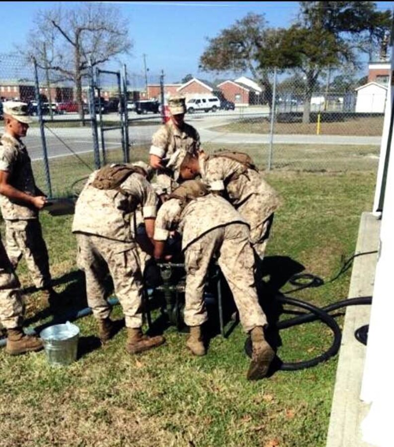 Marines from BWST 5-15 study the characteristics and capabilities of Containerized Batch Laundry operations.