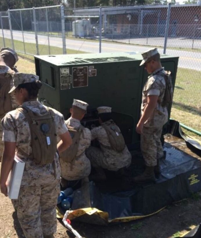 Marines from BWST 5-15 study the characteristics and capabilities of Containerized Batch Laundry operations.
