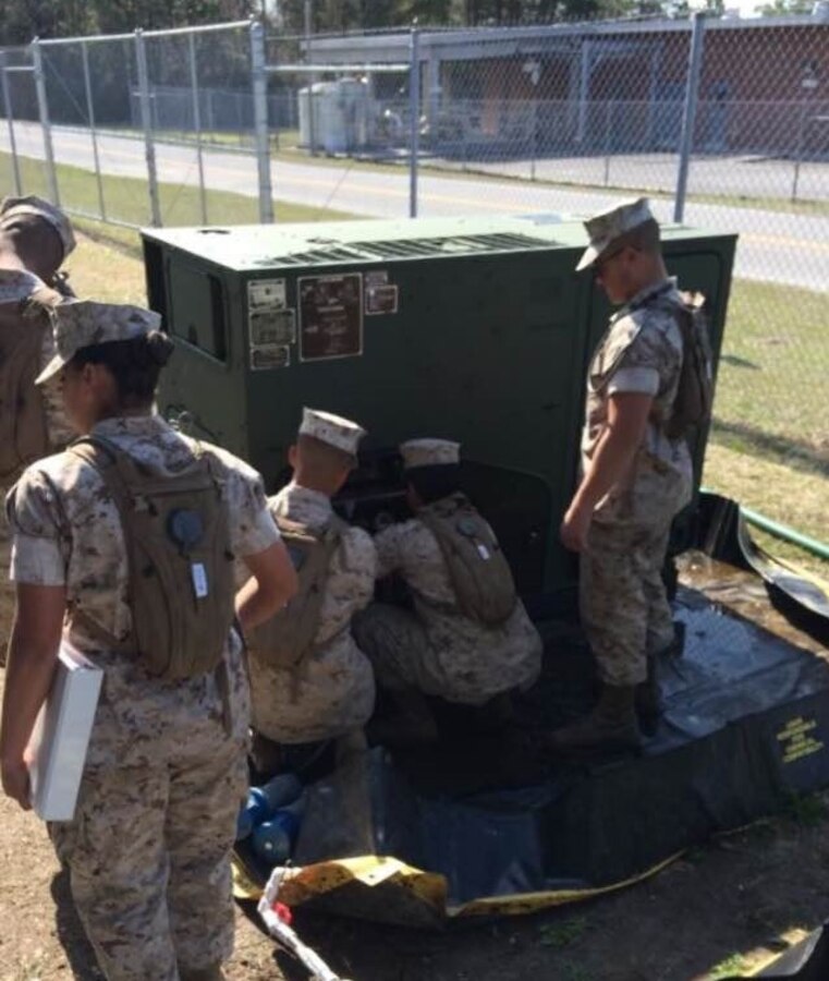 Marines from BWST 5-15 study the characteristics and capabilities of Containerized Batch Laundry operations.