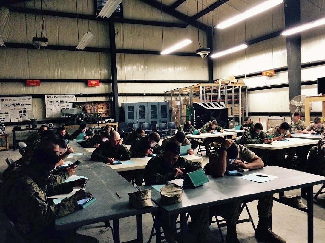 Marines from BWST 3-15 use Kindles to review the different systems and components of the Tactical Water Purification System.