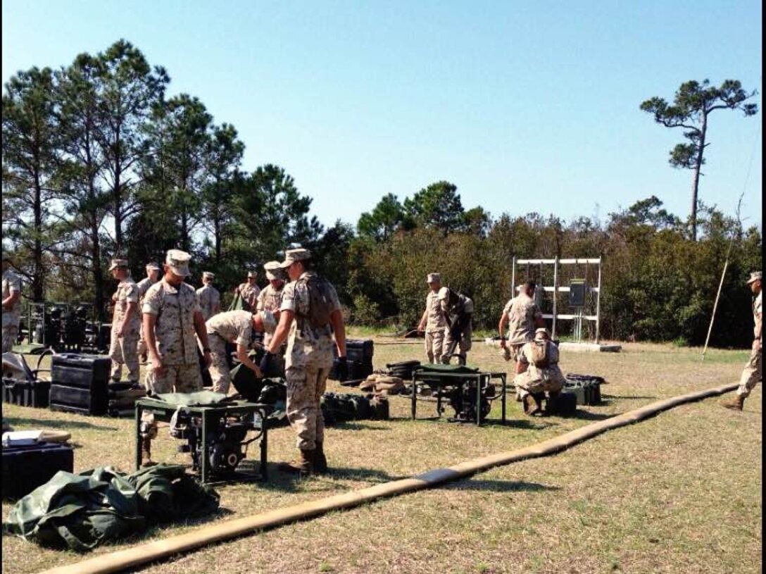 Marines from BWST 4-15 conduct practical application on set up and operation of the Light Weight Water Purification System.