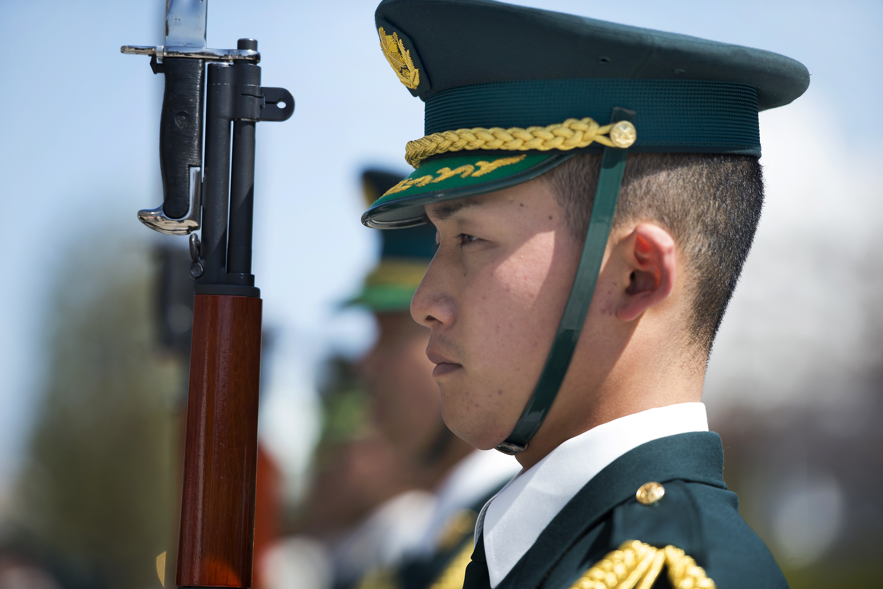 A member of the Japanese honor guard stands at attention during a