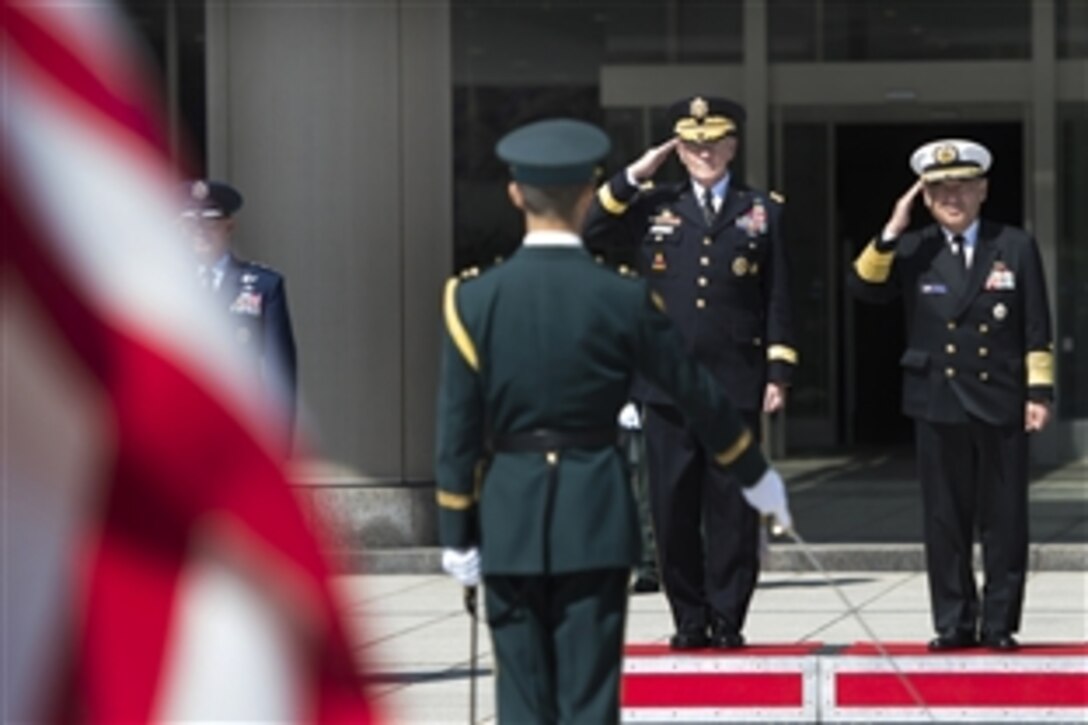 U.S. Army Gen. Martin E. Dempsey, second from right, chairman of the Joint Chiefs of Staff, and Japanese Adm. Katsutoshi Kawano render honors during a ceremony in Dempsey's honor at the Ministry of Defense in Tokyo, March 25, 2015. Dempsey is visiting Japan as part of a two-day trip to reinforce the U.S.-Japan alliance.