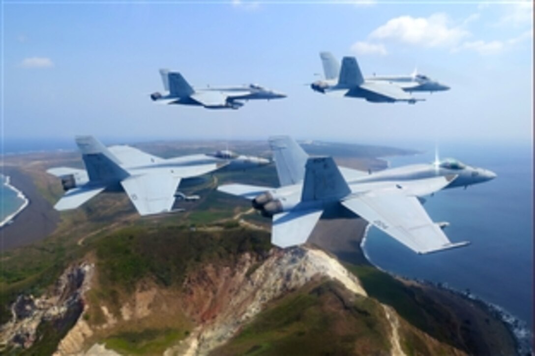 F/A-18E Super Hornets fly over Mt. Suribachi to mark the 70th anniversary of the Battle of Iwo Jima, Japan, March 25, 2015, during a return transit to Atsugi, Japan. The squadron, part of Carrier Air Wing 5, is deployed to Naval Air Facility Atsugi, Japan, to support security and stability in the Indo-Asia-Pacific region. The Hornets are assigned to Strike Fighter Squadron 27. 