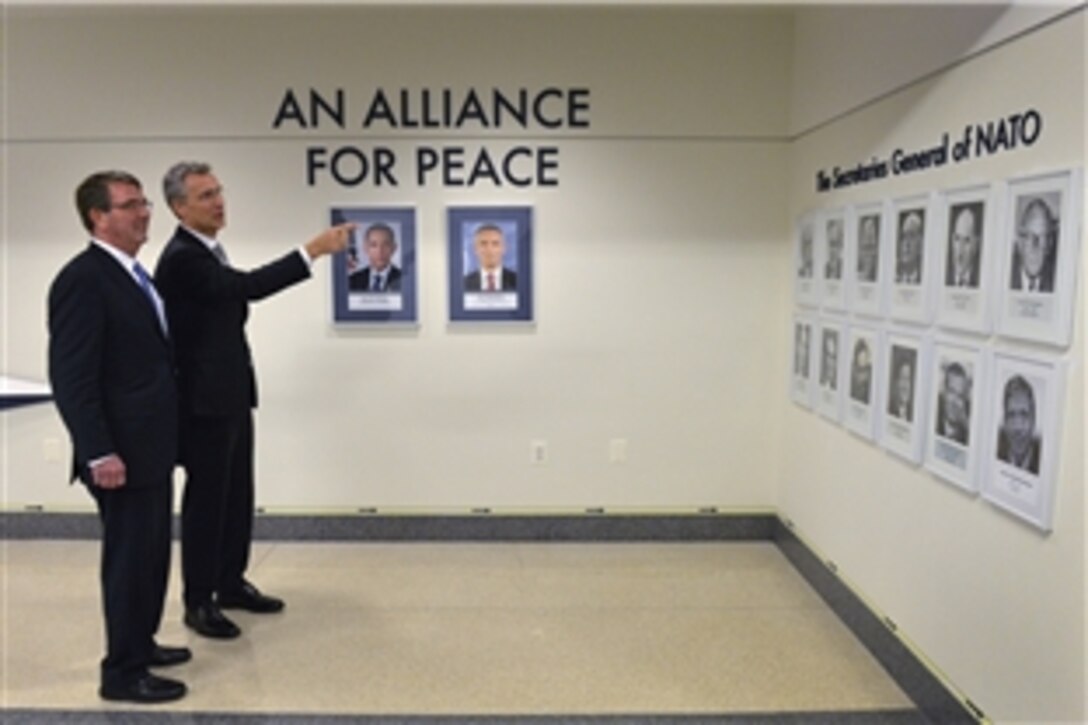 U.S. Defense Secretary Ash Carter shows NATO Secretary General Jens Stoltenberg the display honoring the NATO alliance during a tour of the Pentagon, March 26, 2015. 