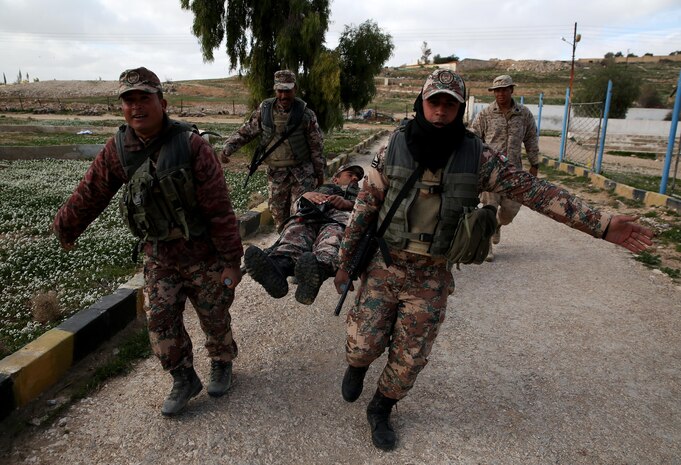 U.S. Navy Seaman Jeremy Hernandez, a corpsman with Company G, 2nd Battalion, 7th Marine Regiment, Special Purpose Marine Air Ground Task Force – Crisis Response – Central Command, supervises a group of Jordanian soldiers as they carry a simulated casualty on a stretcher in the U.S. Central Command area of operations, Feb. 8, 2015. U.S. Marines and sailors guided Jordanian soldiers through four stations where they learned and practiced various combat life saver skills. (U.S. Marine Corps photo by Cpl. Carson A. Gramley/Released)