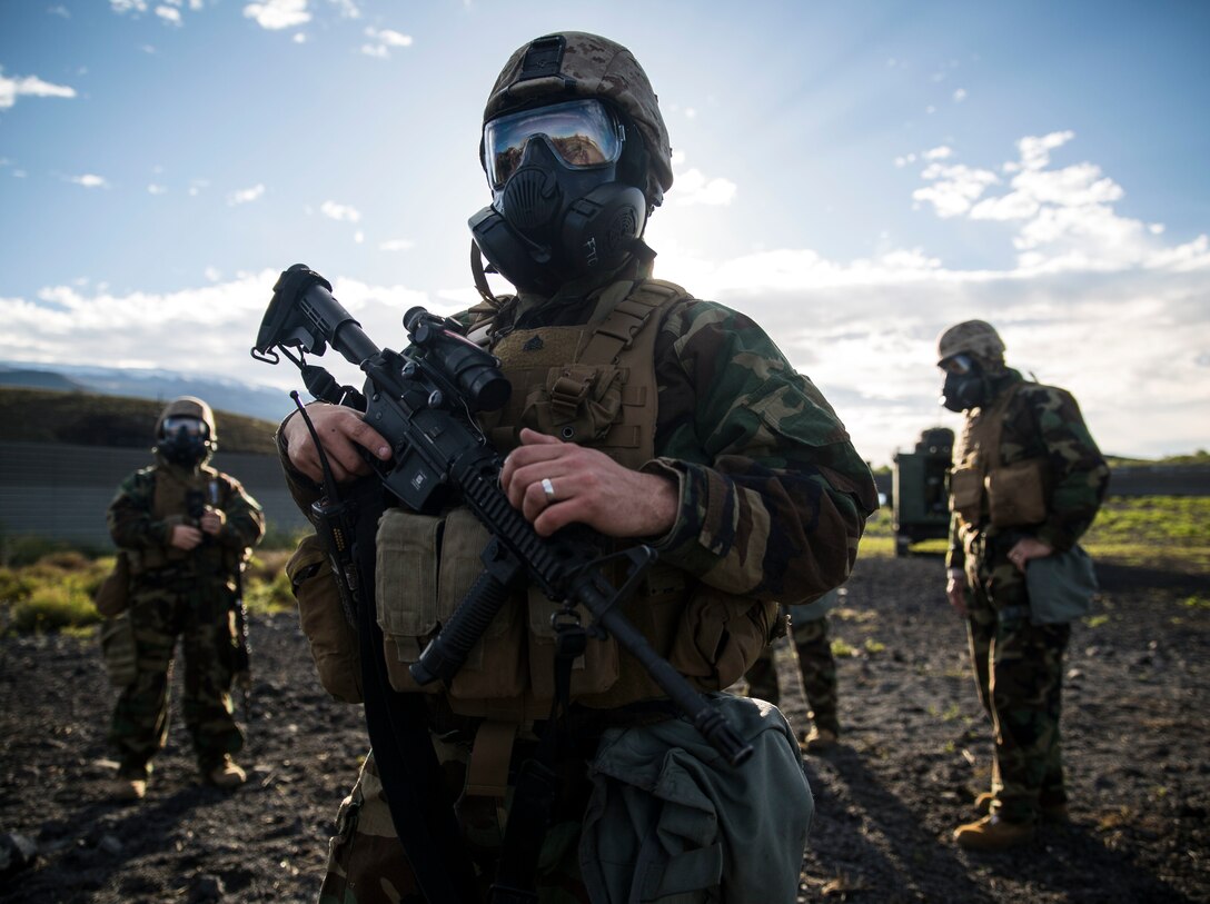 Sgt. James N. Morley listens to a convoy brief that will determine the route to the decontamination site after a chemical attack scenario March 13 during Dragon Fire Exercise 15-2 at Pohakuloa Training Area, Hawaii. Morley, a Kokomo, Indiana, native, is a radio operator and radio supervisor with Headquarters Battery, 12th Marine Regiment, 3rd Marine Division, III Marine Expeditionary Force. 