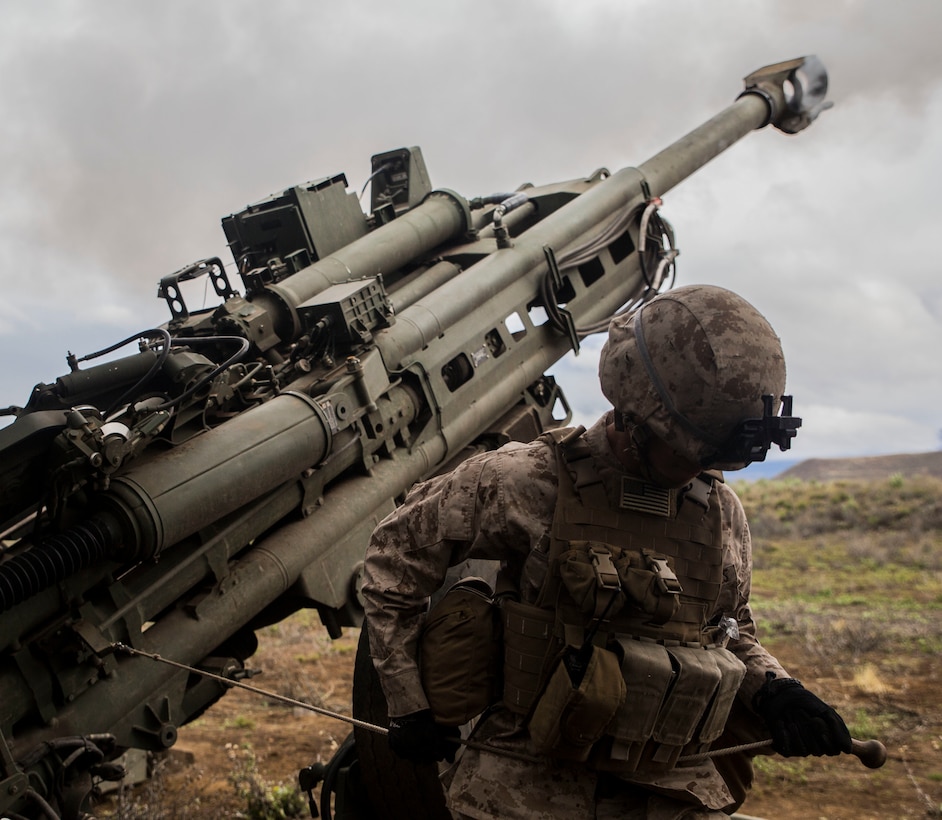 Cpl. Calvin V. Montgomery uses his whole body to pull the lanyard of an M777 Howitzer, firing a 155 mm round March 11 during Dragon Fire Exercise 15-2 at Pohakuloa Training Area, Hawaii. Howitzers are used by artillery batteries to provide suppressing fire for ground units. Montgomery, an Eatonton, Georgia, native, is a radio operator with Headquarters Battery, 12th Marine Regiment, 3rd Marine Division, III Marine Expeditionary Force.