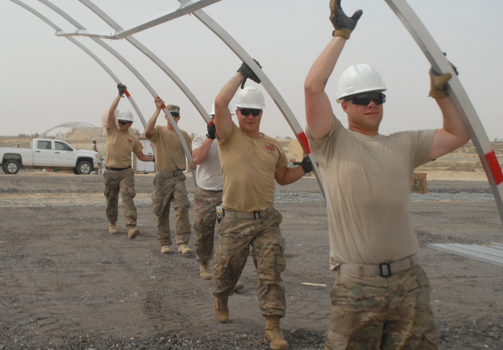 Members of the 1313th Engineer Company move the skeleton of a tent at the 332nd Air Expeditionary Group March 19, 2015.  Members of the Indiana National Guard came together to build 60 tents for personnel deployed in support of Operation Inherent Resolve. (U.S. Air Force photo by 1st Lt. Sarah Ruckriegle)