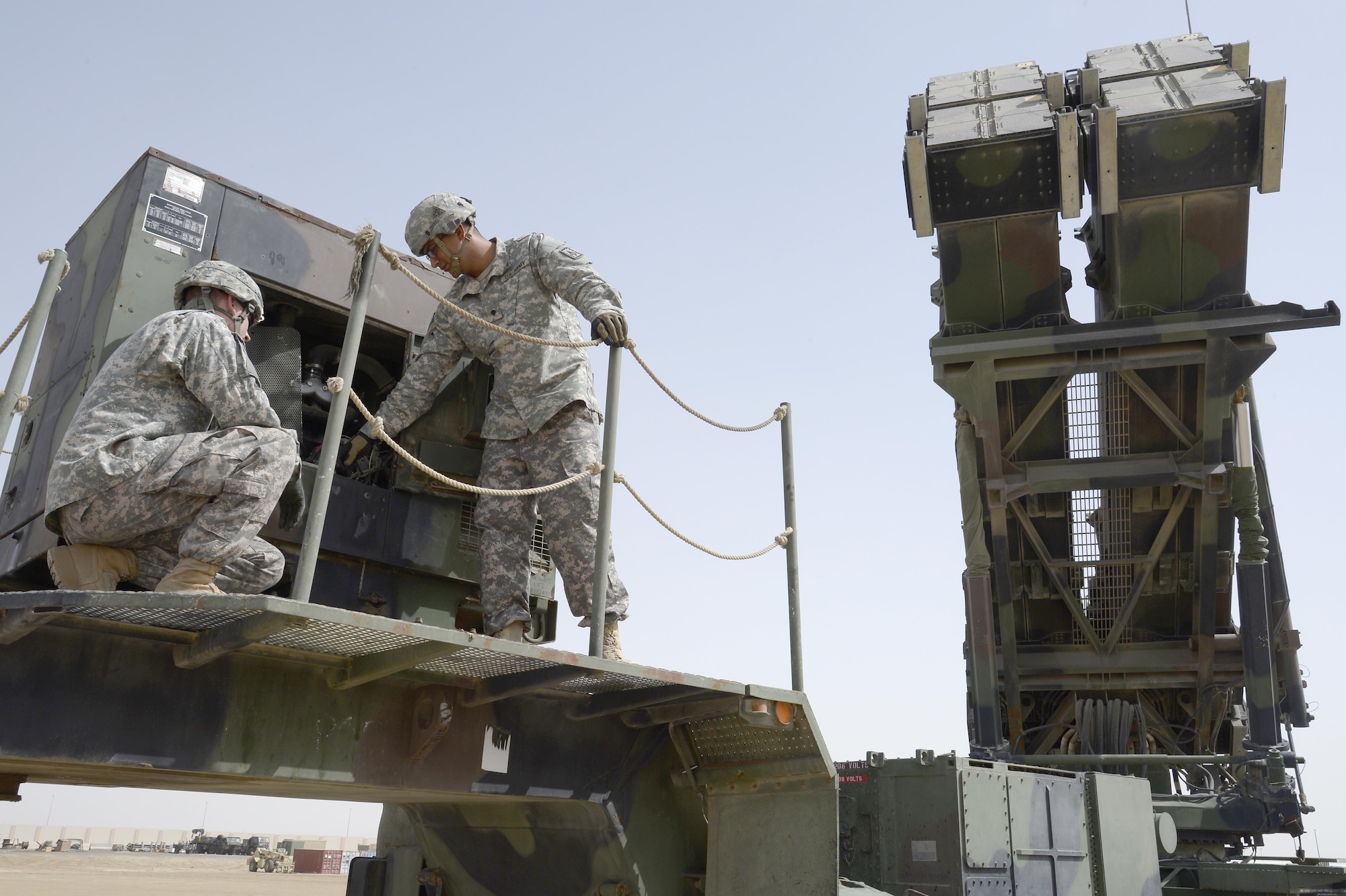 U.S. Army Specialist Cody, right, launching station control member, teaches U.S. Army Private First Class Joshua, tactical control assistant, how to conduct preventative maintenance checks on a launcher station at an undisclosed location in Southwest Asia March 18, 2015. The Bravo Battery mission is to neutralize theatre ballistic missile and aerial attacks against our defended assets in support of the combatant commander’s strategic objectives to allow U.S. coalition forces freedom of maneuver. (U.S. Air Force photo/Tech. Sgt. Marie Brown/RELEASED)