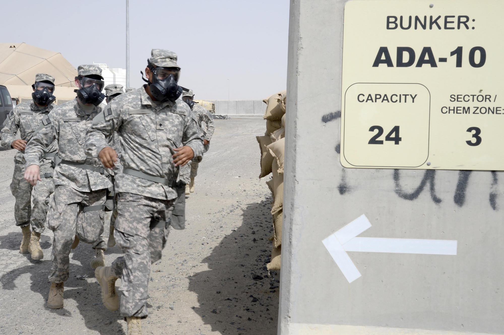 Soldiers with Bravo Battery run to a bunker during a training exercise at an undisclosed location in Southwest Asia, March 18, 2015. On a day-to-day basis the Soldiers of Bravo Battery train to improve their knowledge base to ensure they are ready to fight. (U.S. Air Force photo/Tech. Sgt. Marie Brown/RELEASED)