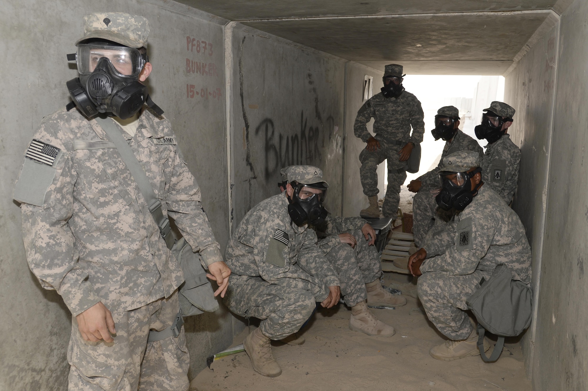 Soldiers with Bravo Battery take cover in a bunker during a training exercise at an undisclosed location in Southwest Asia, March 18, 2015. Whether it’s an exercise scenario or a real-world threat, the Soldiers of Bravo Battery stand ready to operate the Patriots, should they be needed to defend the base. (U.S. Air Force photo/Tech. Sgt. Marie Brown/RELEASED)