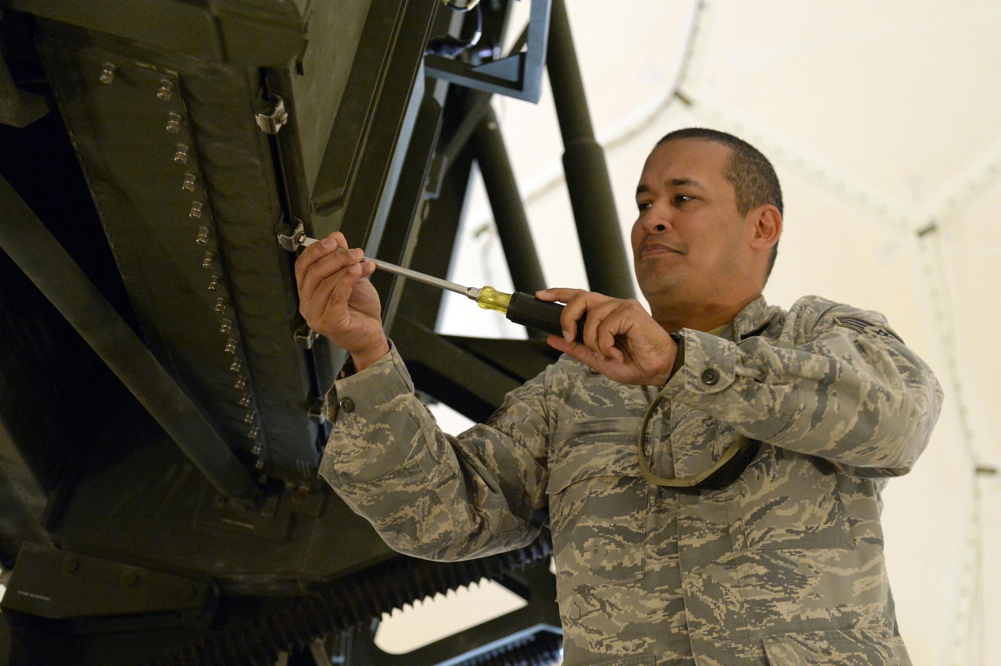 Staff Sgt. Pedro, radar maintenance technician, prepares a TPS-75 radar antenna for a performance maintenance inspection at an undisclosed location in Southwest Asia March 24, 2015. Airmen with the Expeditionary Air Control Squadron radar maintenance perform daily maintenance to ensure the radars are operational. Pedro is currently deployed from the Air National Guard’s 141st Air Control Squadron out of Ramey Air Force Base, Puerto Rico. (U.S. Air Force photo/Tech. Sgt. Brown/RELEASED)