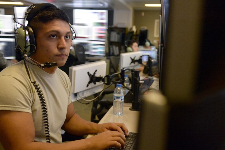 Senior Airman Isaac, command and control battlefield manager surveillance technician, monitors air traffic for possible tracks of interest at an undisclosed location in Southwest Asia March 24, 2015. Airmen with the Expeditionary Air Control Squadron provide command and control for 876,000 square miles across the entire area of responsibility. Isaac is currently deployed from Spangdahlem Air Base, Germany. (U.S. Air Force photo/Tech. Sgt. Brown/RELEASED)