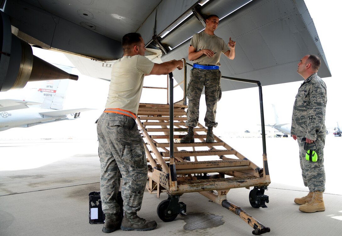 U.S. Air Force Capt. James Henry, right, 379th Air Expeditionary Wing chaplain, speaks with Airmen from the 340th Expeditionary Aircraft Maintenance Unit, March 27, 2015, at Al Udeid Air Base, Qatar. Although maintenance Airmen don’t work typical office hours, Henry and his assistant, Tech. Sgt. Michael James, 379th AEW chaplain’s assistant, adjust their hours so that they can see Airmen from each and every shift. (U.S. Air Force photo by Senior Airman Kia Atkins)