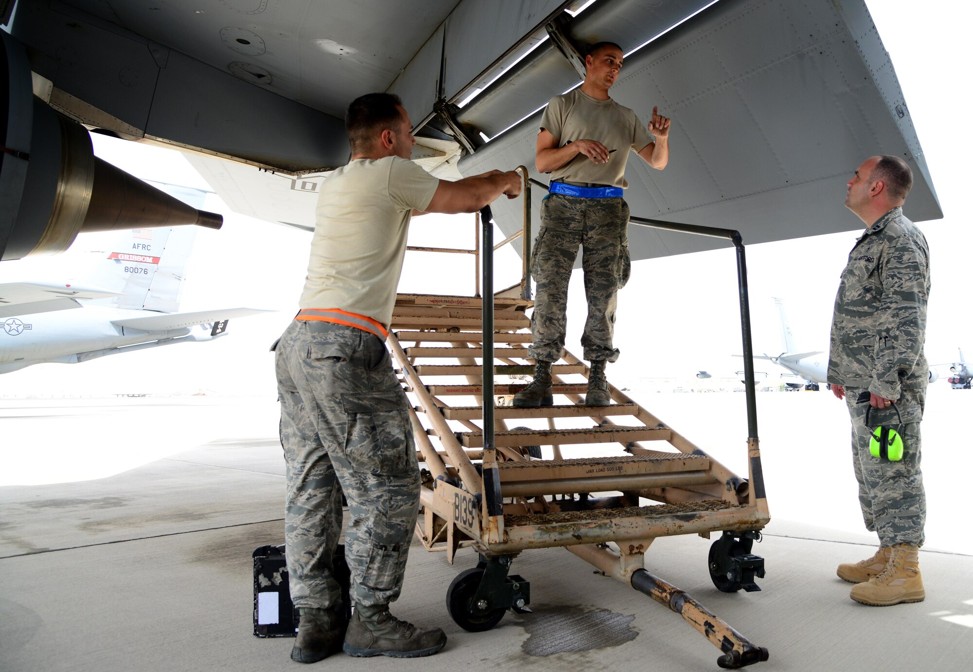U.S. Air Force Capt. James Henry, right, 379th Air Expeditionary Wing chaplain, speaks with Airmen from the 340th Expeditionary Aircraft Maintenance Unit, March 27, 2015, at Al Udeid Air Base, Qatar. Although maintenance Airmen don’t work typical office hours, Henry and his assistant, Tech. Sgt. Michael James, 379th AEW chaplain’s assistant, adjust their hours so that they can see Airmen from each and every shift. (U.S. Air Force photo by Senior Airman Kia Atkins)
