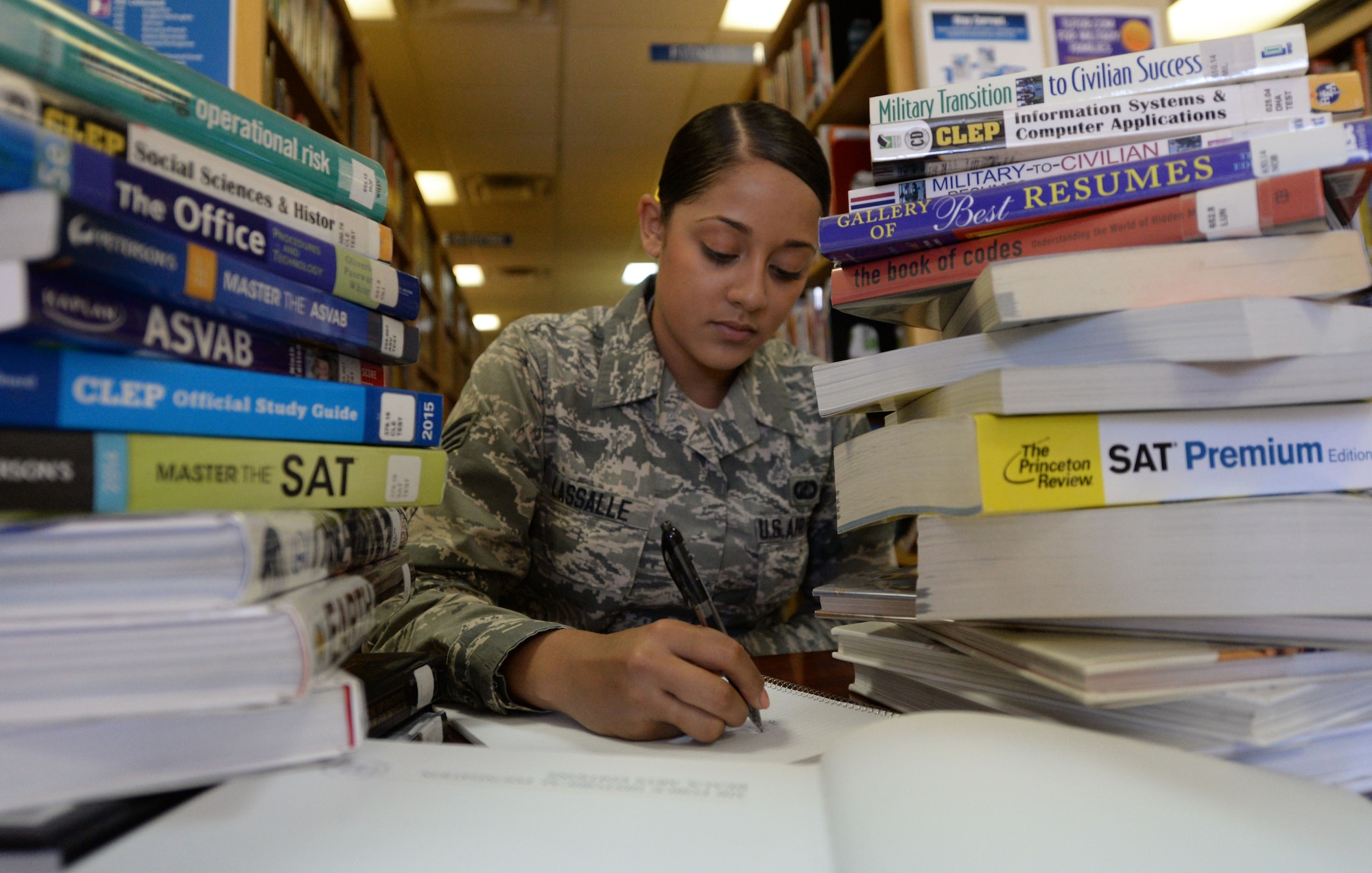 U.S. Air Force Senior Airman Kayla Lassalle, 27th Special Operations Contracting Squadron contracting specialist, makes use of library resources March 25, 2015 at Cannon Air Force Base, N.M. The Air Force recently made several changes to the tuition assistance program that could affect some recipients of TA in significant ways. (U.S. Air Force photo illustration/Staff Sgt. Alex Mercer)